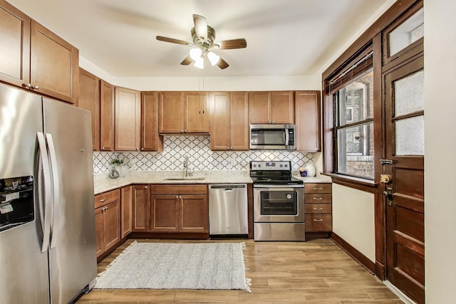 5520 S Cornell Ave Unit 1S, Chicago, IL 60637 - kitchen with stainless steel appliances, a ceiling fan, light wood-style flooring, and backsplash