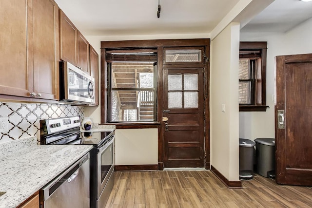 5520 S Cornell Ave Unit 1S, Chicago, IL 60637 - kitchen with appliances with stainless steel finishes, light wood-type flooring, light countertops, and tasteful backsplash