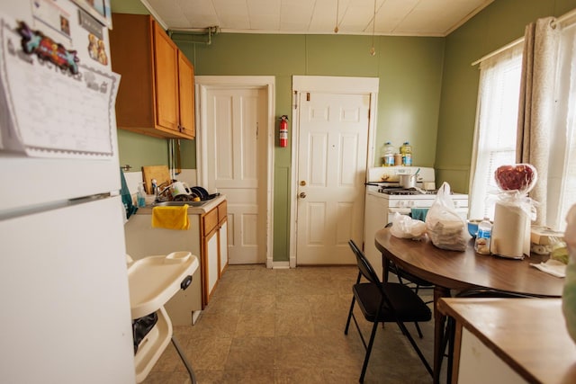 341 S 5th Ave, Kankakee, IL 60901 - kitchen featuring white appliances and brown cabinets