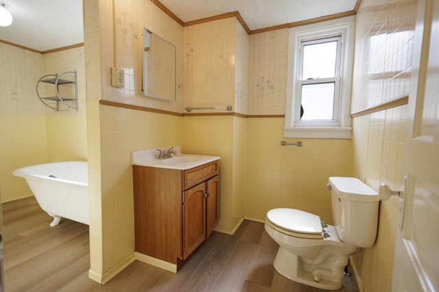 341 S 5th Ave, Kankakee, IL 60901 - full bath featuring ornamental molding, wood finished floors, a freestanding tub, vanity, and toilet