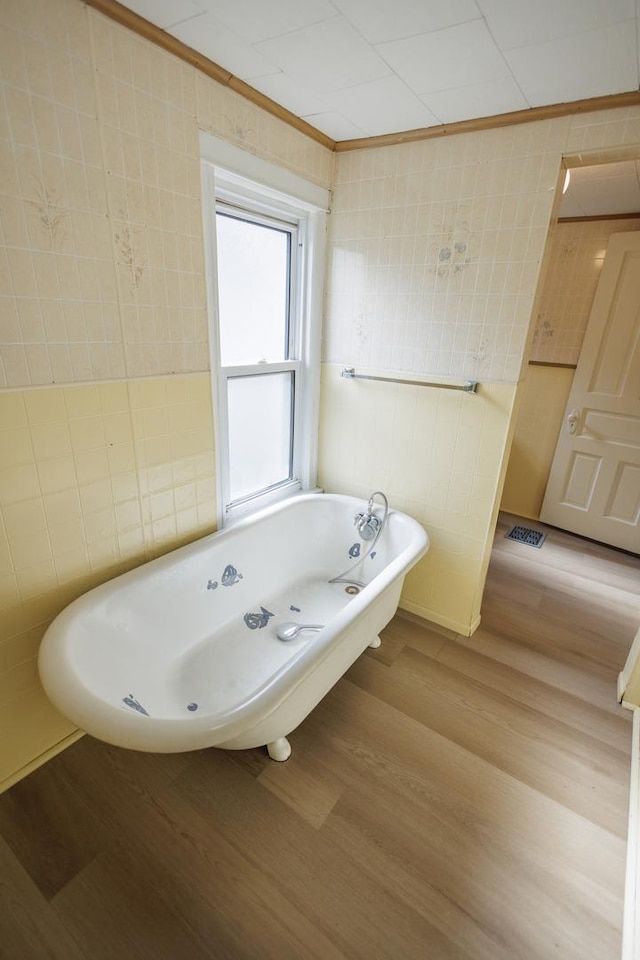 341 S 5th Ave, Kankakee, IL 60901 - bathroom featuring crown molding, a soaking tub, and wood finished floors