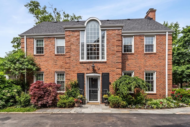 1414 Lincoln St, Evanston, IL 60201 - view of front of home with brick siding, a chimney, and roof with shingles