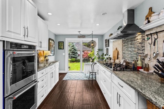 1414 Lincoln St, Evanston, IL 60201 - kitchen with island exhaust hood, stainless steel double oven, backsplash, dark wood finished floors, and white cabinetry