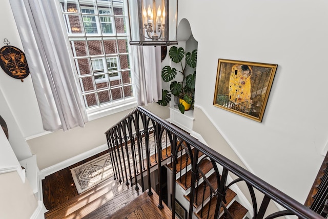 1414 Lincoln St, Evanston, IL 60201 - stairway featuring a chandelier, plenty of natural light, and arched walkways