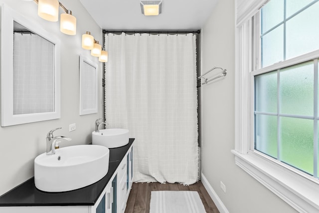 1414 Lincoln St, Evanston, IL 60201 - full bathroom with plenty of natural light, wood finished floors, and double vanity
