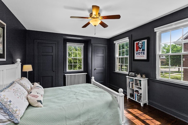 1414 Lincoln St, Evanston, IL 60201 - bedroom featuring multiple windows, dark wood-style floors, radiator heating unit, and a ceiling fan
