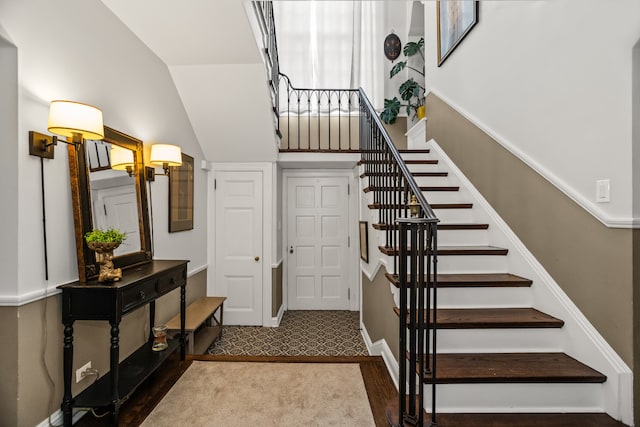 1414 Lincoln St, Evanston, IL 60201 - staircase featuring vaulted ceiling and baseboards