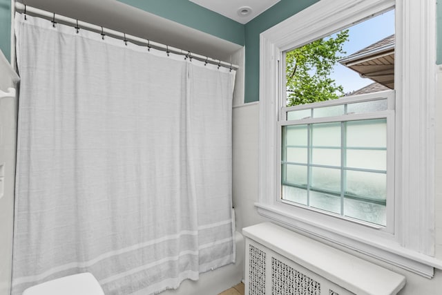1414 Lincoln St, Evanston, IL 60201 - full bathroom with radiator heating unit and shower / bath combination with curtain