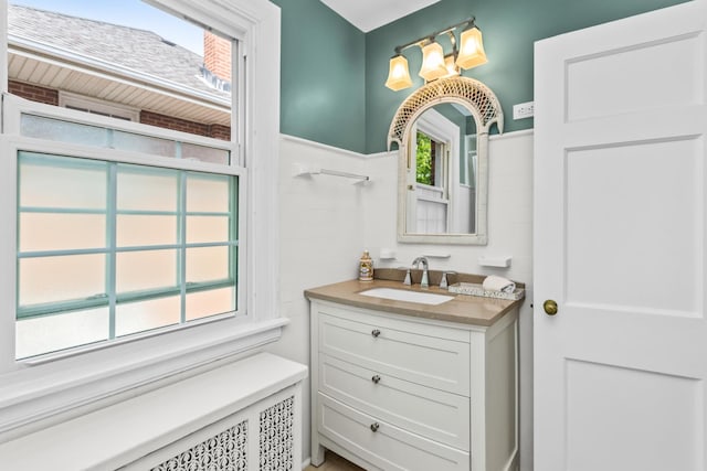 1414 Lincoln St, Evanston, IL 60201 - bathroom with vanity, radiator heating unit, plenty of natural light, and a wainscoted wall