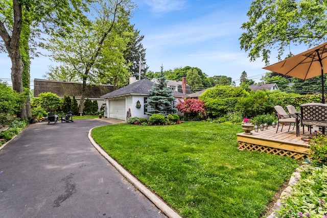 1414 Lincoln St, Evanston, IL 60201 - view of front of home featuring a garage, a front lawn, a deck, asphalt driveway, and a chimney