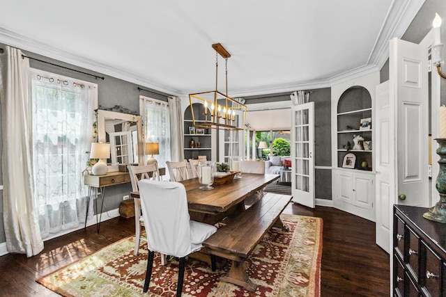 1414 Lincoln St, Evanston, IL 60201 - dining space featuring ornamental molding, healthy amount of natural light, a chandelier, dark wood-type flooring, and built in features