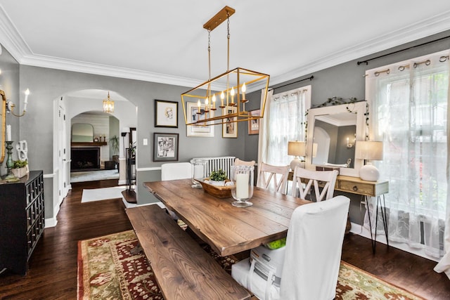 1414 Lincoln St, Evanston, IL 60201 - dining space featuring arched walkways, crown molding, wood finished floors, a chandelier, and radiator