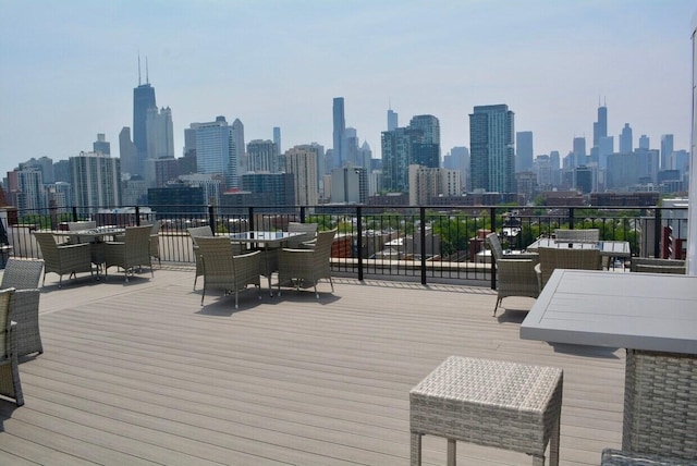 1444 N Orleans St Unit 6C, Chicago, IL 60610 - wooden deck featuring a view of skyline and outdoor dining space
