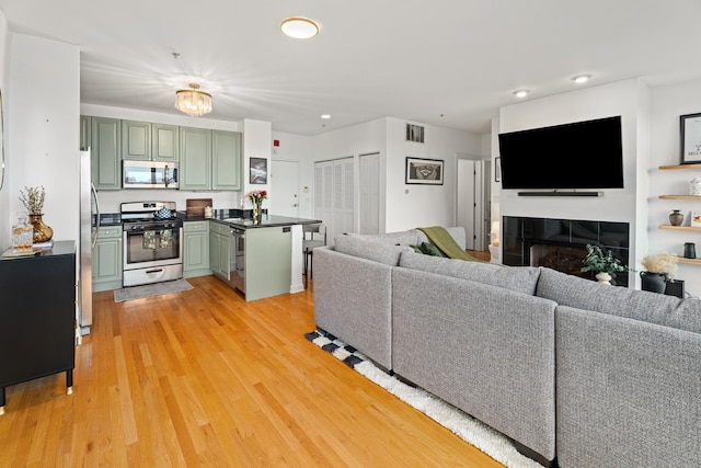 1444 N Orleans St Unit 6C, Chicago, IL 60610 - living room featuring light wood-style flooring, a fireplace, and recessed lighting