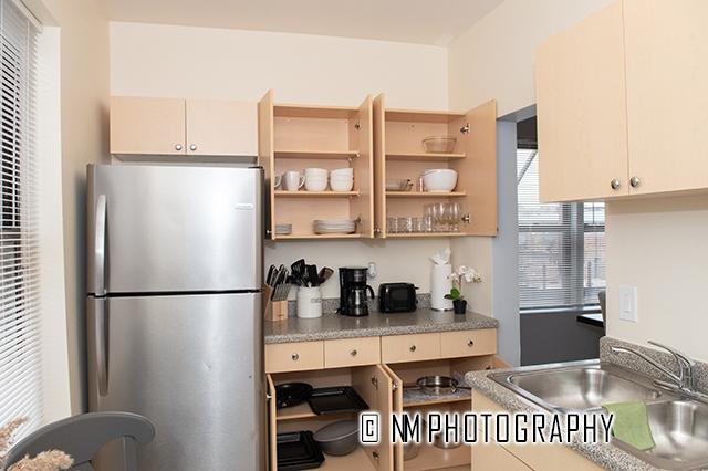 1942 E 74th St Unit 3B, Chicago, IL 60649 - kitchen with freestanding refrigerator, a sink, light countertops, a heating unit, and cream cabinetry