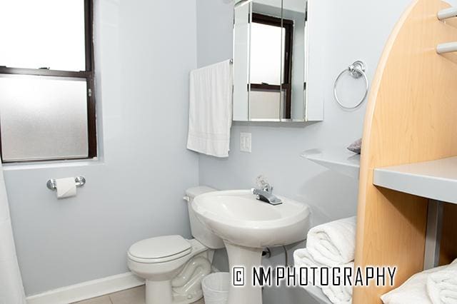 1942 E 74th St Unit 3B, Chicago, IL 60649 - bathroom with tile patterned floors, toilet, and baseboards