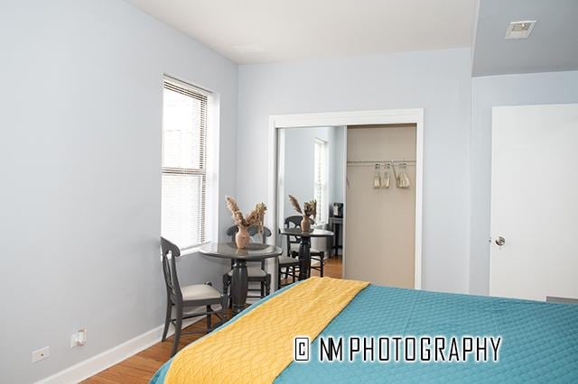 1942 E 74th St Unit 3B, Chicago, IL 60649 - bedroom featuring a closet, wood finished floors, and baseboards
