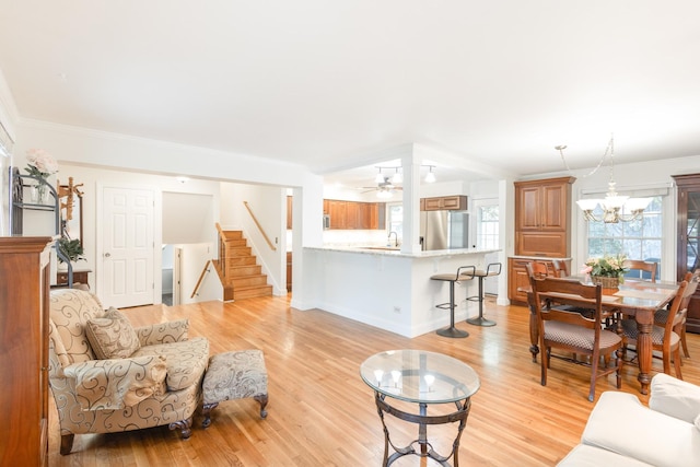 0N244 Peter Rd, Winfield, IL 60190 - living area featuring stairs, light wood-type flooring, crown molding, and a ceiling fan
