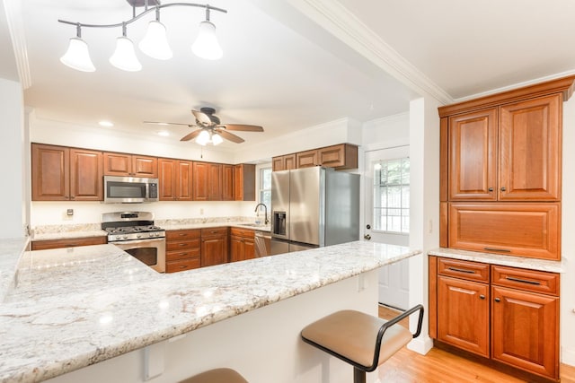0N244 Peter Rd, Winfield, IL 60190 - kitchen featuring stainless steel appliances, a kitchen breakfast bar, ornamental molding, brown cabinetry, and light stone counters