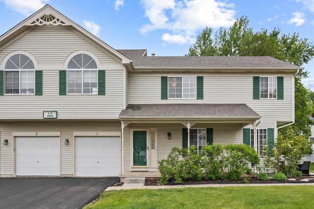 1 W Pheasant Trl, Lake In The Hills, IL 60156 - multi unit property with driveway, an attached garage, covered porch, a front lawn, and roof with shingles