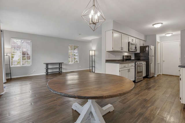 1 W Pheasant Trl, Lake In The Hills, IL 60156 - kitchen with stainless steel appliances, dark countertops, dark wood-style floors, and baseboards