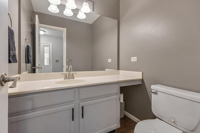 1 W Pheasant Trl, Lake In The Hills, IL 60156 - bathroom featuring toilet, wood finished floors, vanity, and baseboards