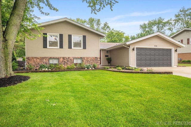 636 Cambridge Dr, Schaumburg, IL 60193 - tri-level home with an attached garage, concrete driveway, a front lawn, and stone siding