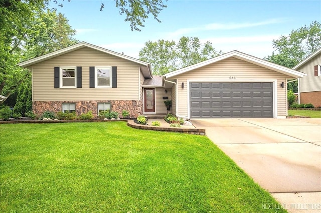 636 Cambridge Dr, Schaumburg, IL 60193 - tri-level home featuring concrete driveway, a garage, a front yard, and stone siding