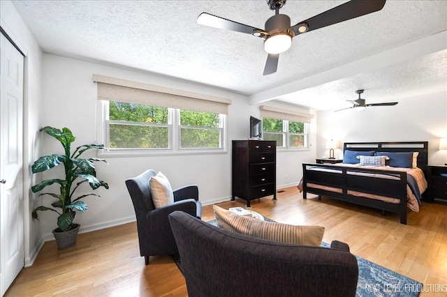 636 Cambridge Dr, Schaumburg, IL 60193 - bedroom featuring a textured ceiling, light wood-style flooring, and ceiling fan