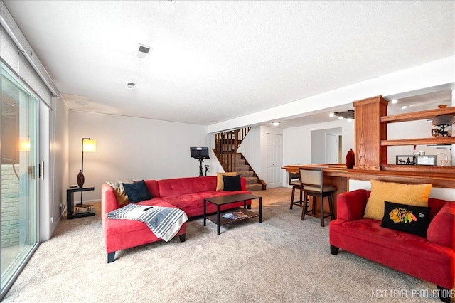 636 Cambridge Dr, Schaumburg, IL 60193 - living area with carpet, stairs, and a textured ceiling