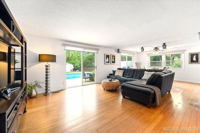 636 Cambridge Dr, Schaumburg, IL 60193 - living room featuring a textured ceiling, light wood-style flooring, and ceiling fan