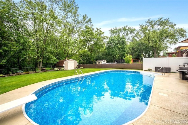 636 Cambridge Dr, Schaumburg, IL 60193 - view of pool with a storage shed, a fenced backyard, view of wooded area, a diving board, and a patio