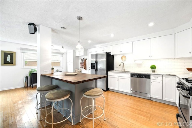 636 Cambridge Dr, Schaumburg, IL 60193 - kitchen with appliances with stainless steel finishes, wood counters, white cabinetry, backsplash, and recessed lighting