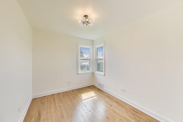 839 N Kildare Ave, Chicago, IL 60651 - unfurnished room with a chandelier, baseboards, and light wood-style floors