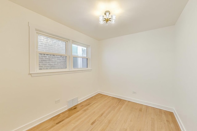 839 N Kildare Ave, Chicago, IL 60651 - empty room with a chandelier, baseboards, and light wood-style floors
