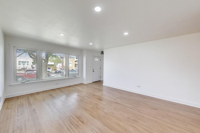 839 N Kildare Ave, Chicago, IL 60651 - unfurnished living room with baseboards, light wood finished floors, and recessed lighting