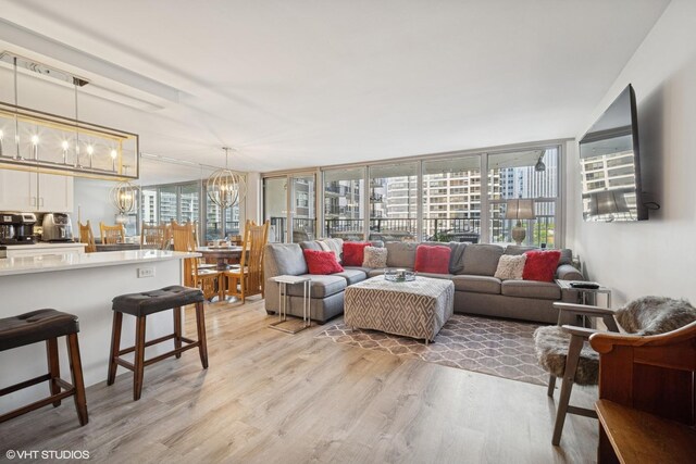 400 E Randolph St Unit 826, Chicago, IL 60601 - living room with light wood-type flooring, a chandelier, and a wall of windows