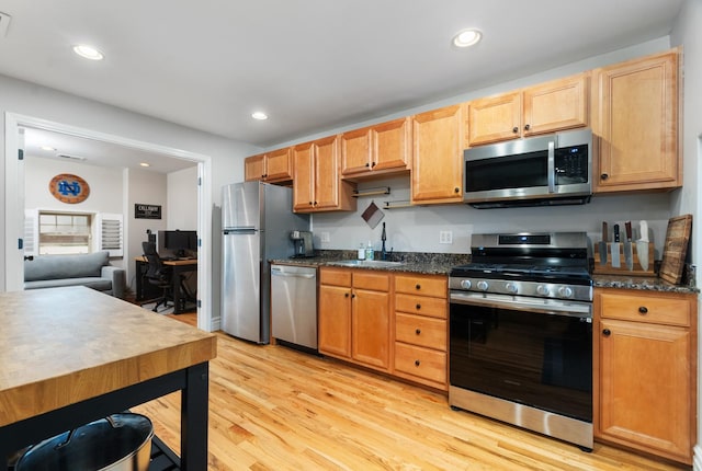 2546 W George St Unit G, Chicago, IL 60618 - kitchen with appliances with stainless steel finishes, light wood-style flooring, a sink, recessed lighting, and dark stone counters