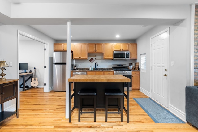 2546 W George St Unit G, Chicago, IL 60618 - kitchen with appliances with stainless steel finishes, light wood-type flooring, a sink, baseboards, and recessed lighting