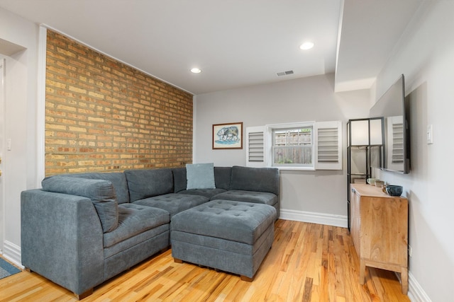 2546 W George St Unit G, Chicago, IL 60618 - living room featuring brick wall, light wood-type flooring, baseboards, recessed lighting, and an accent wall