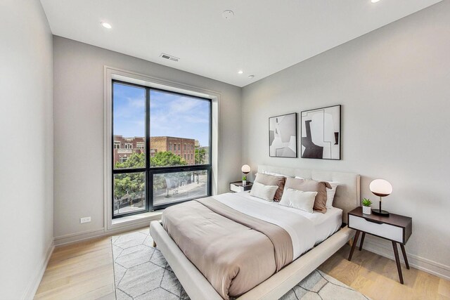 613 N Ogden Ave Unit 2E, Chicago, IL 60642 - bedroom with light wood-style floors, baseboards, and recessed lighting