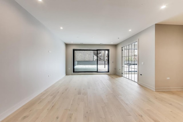 613 N Ogden Ave Unit 2E, Chicago, IL 60642 - spare room featuring light wood-style flooring, baseboards, and recessed lighting