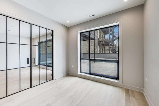 613 N Ogden Ave Unit 2E, Chicago, IL 60642 - unfurnished room with wood finished floors, baseboards, and recessed lighting