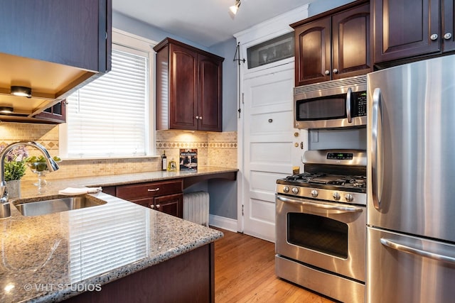 1208 W Waveland Ave Unit 1, Chicago, IL 60613 - kitchen with stainless steel appliances, light wood-style floors, light stone counters, and tasteful backsplash