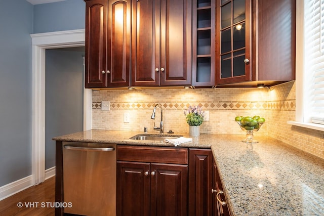 1208 W Waveland Ave Unit 1, Chicago, IL 60613 - kitchen with stainless steel dishwasher, tasteful backsplash, light stone counters, glass insert cabinets, and dark wood-style floors