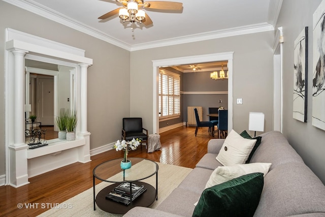 1208 W Waveland Ave Unit 1, Chicago, IL 60613 - living room featuring radiator heating unit, crown molding, wood finished floors, a ceiling fan, and decorative columns