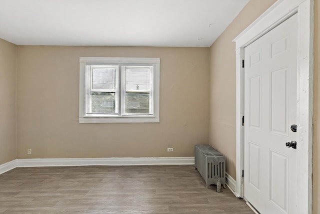 161 E 25th St, Chicago Heights, IL 60411 - unfurnished room featuring radiator, light wood-style flooring, and baseboards