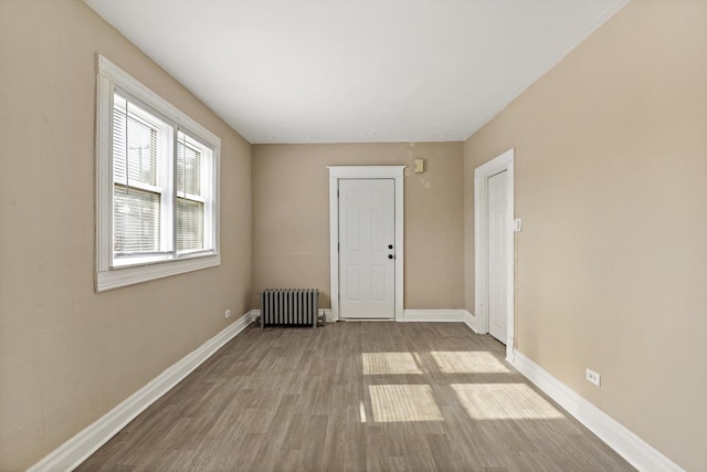161 E 25th St, Chicago Heights, IL 60411 - empty room featuring radiator, wood finished floors, and baseboards