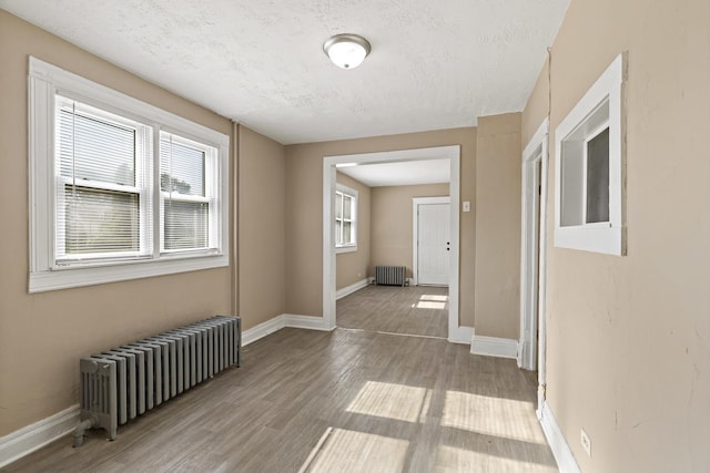 161 E 25th St, Chicago Heights, IL 60411 - hall featuring radiator heating unit, wood finished floors, baseboards, and a textured ceiling