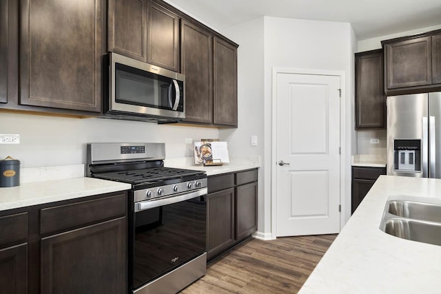 14712 S Azalia Cir, Plainfield, IL 60544 - kitchen with appliances with stainless steel finishes, wood finished floors, dark brown cabinetry, and light countertops